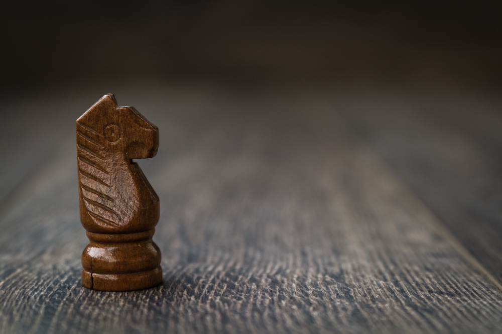 Black Knight, Chess Piece On A Wooden Table