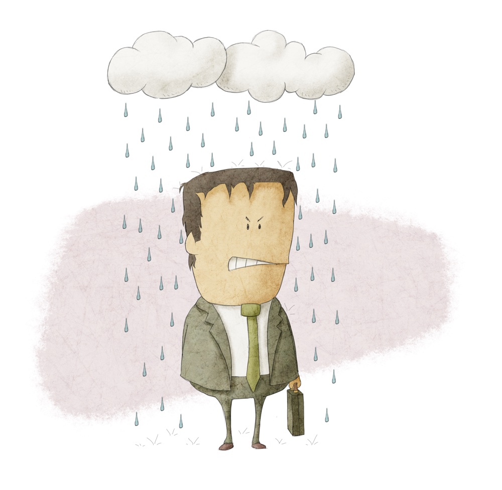 a businessman under rain clouds