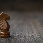 Black Knight, Chess Piece On A Wooden Table
